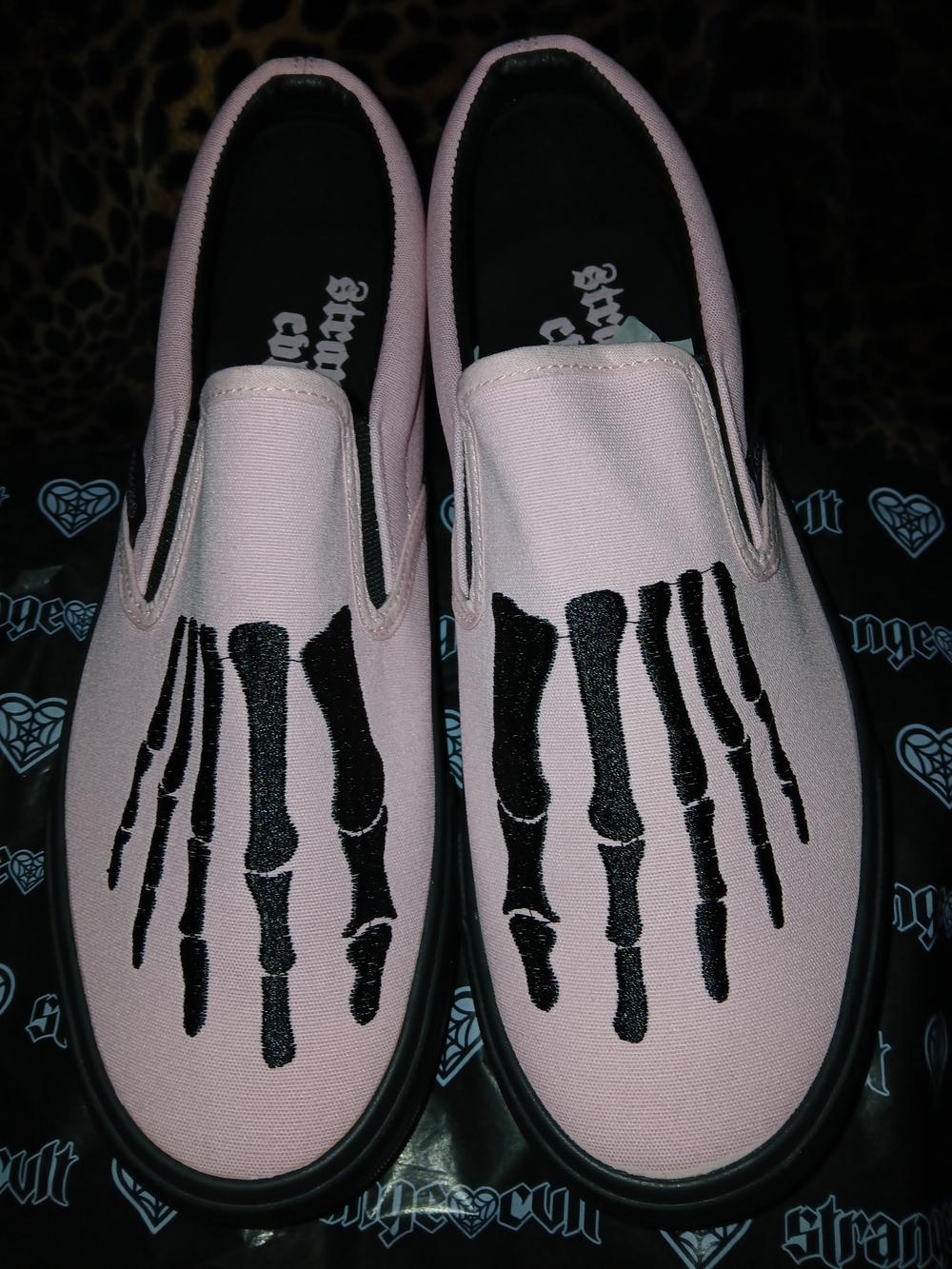 Pink Slip-On Sneakers with Black Skeleton Graphic